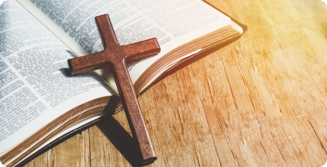 Wooden cross on open Bible